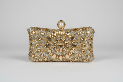 Gold clutch bag with intricate design and pearl clasp 