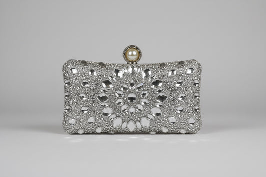 Silver clutch bag with intricate design and pearl clasp